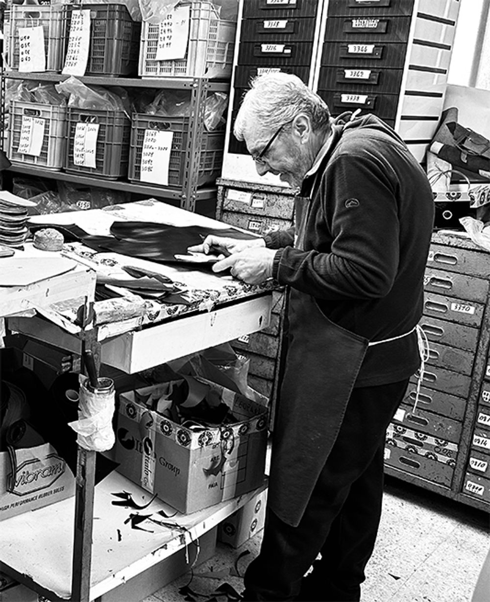 Jasperosso shoemaker in workshop Cutting leather for men’s luxury sneakers.