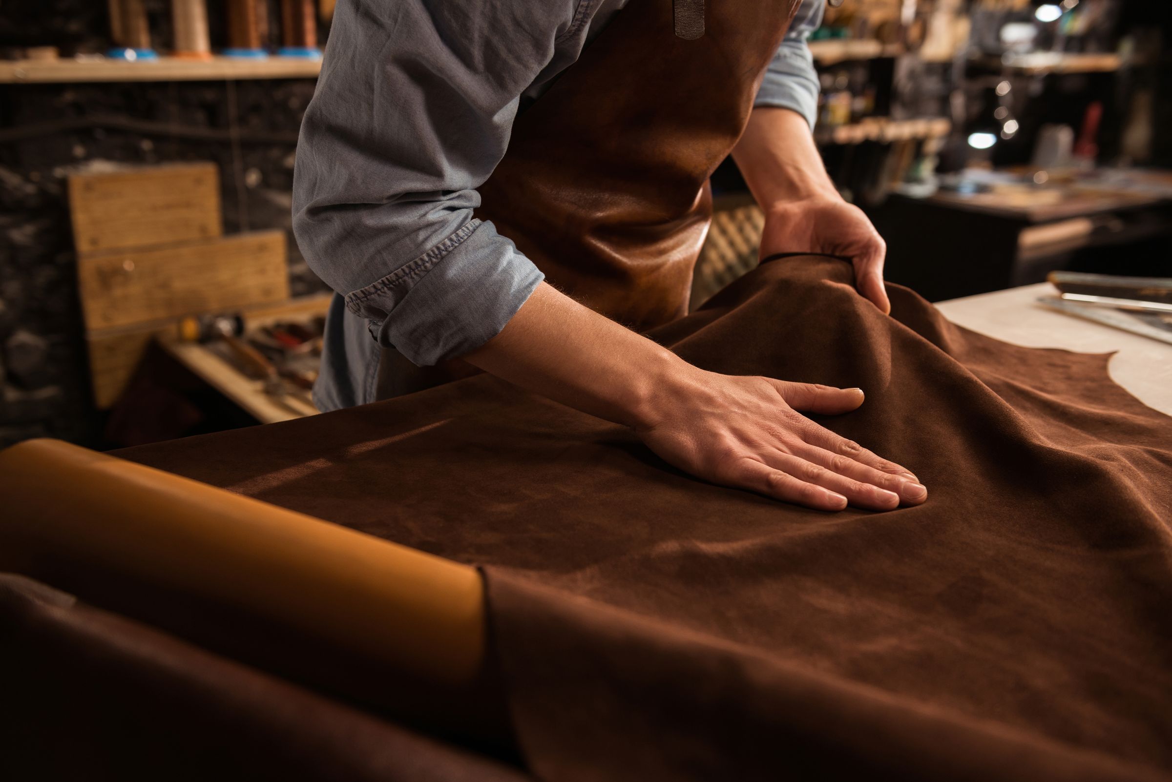 Jasperosso shoemaker making a pattern with a leather hide.