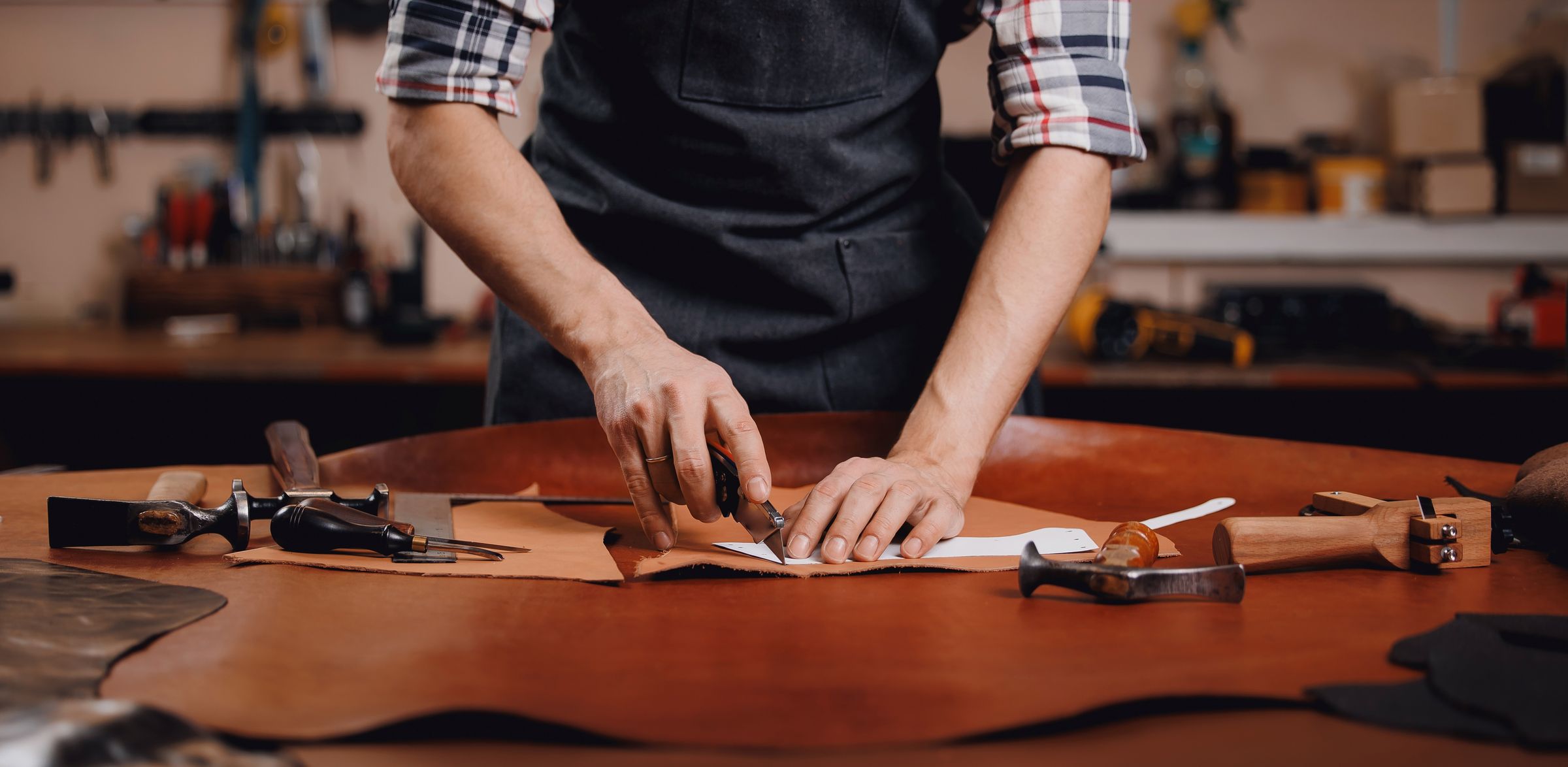 Jasperosso pattern maker cutting calf leather to be used in making luxury sneakers.