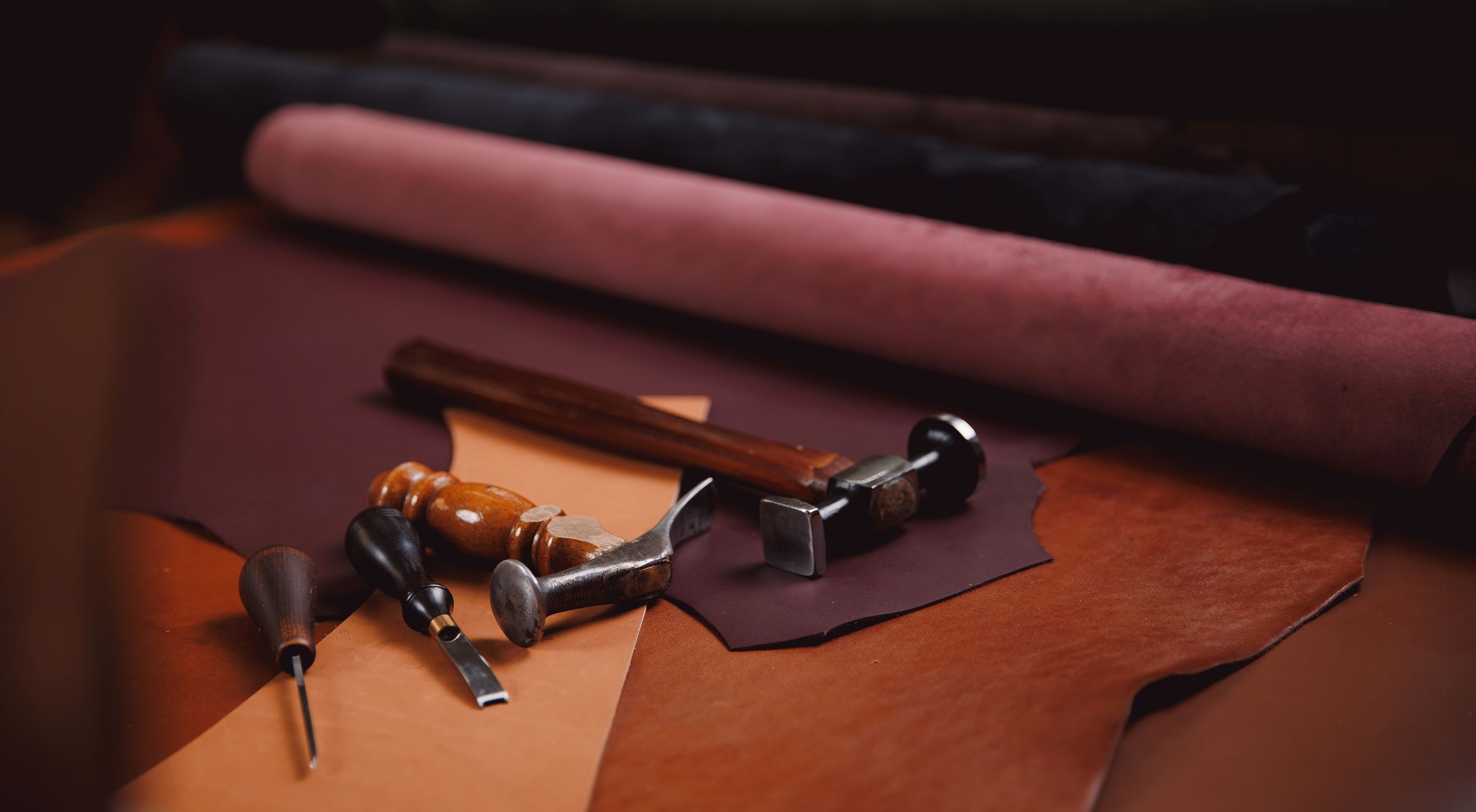 Shoemaking tools with leather cutting and hide.