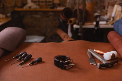 Shoe tools with belt on leather used to make Jasperosso luxury sneakers.