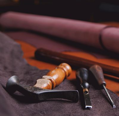 Jasperosso shoemaker measuring and cutting calf leather for making men’s luxury sneakers