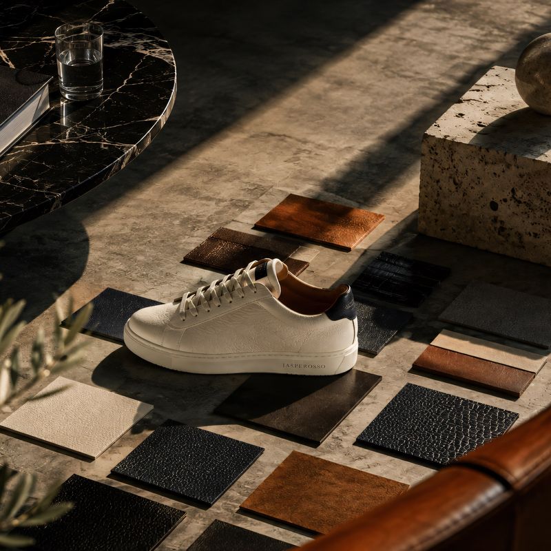 Jasperosso sneaker in white calf leather on marble display