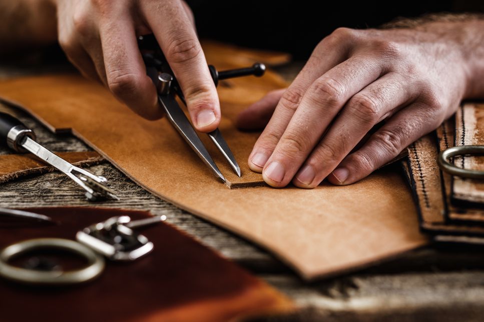 A Jasperosso shoemaker displaying artisanal shoemaking techniques while making men’s luxury sneakers.